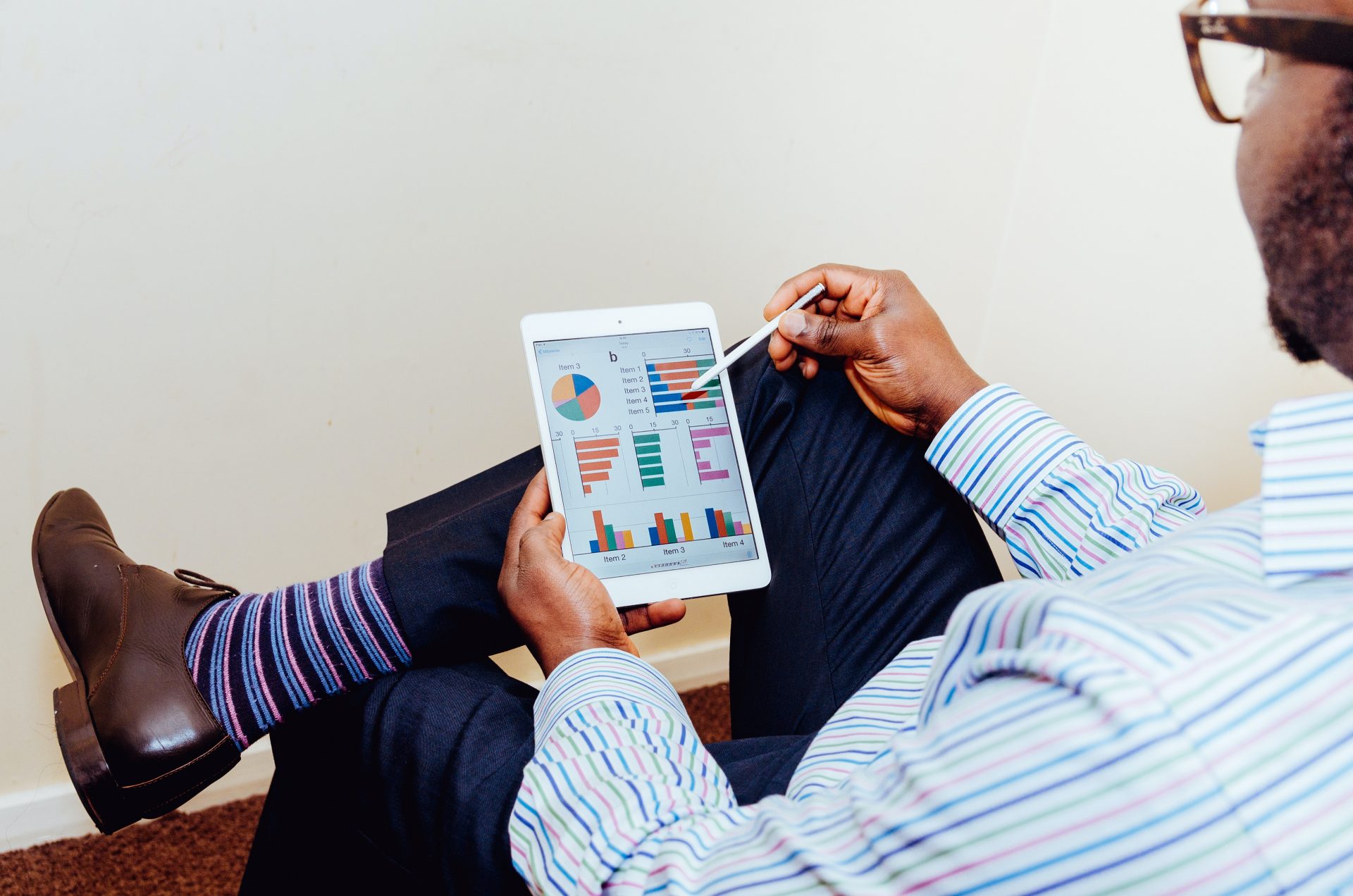 Person sitting on chair holding iPad