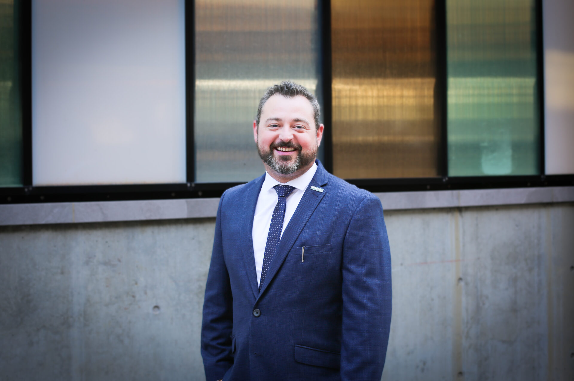 photo of Adam Costantini in a blue suit