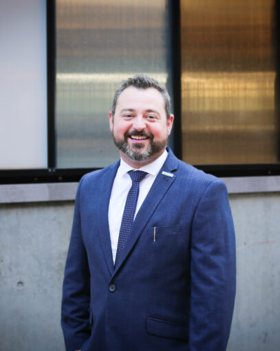photo of Adam Costantini in a blue suit