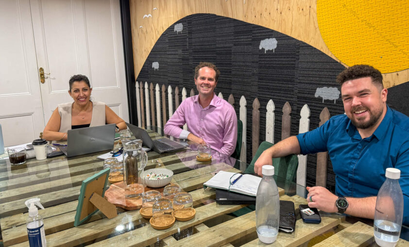 photo of three people in a meeting